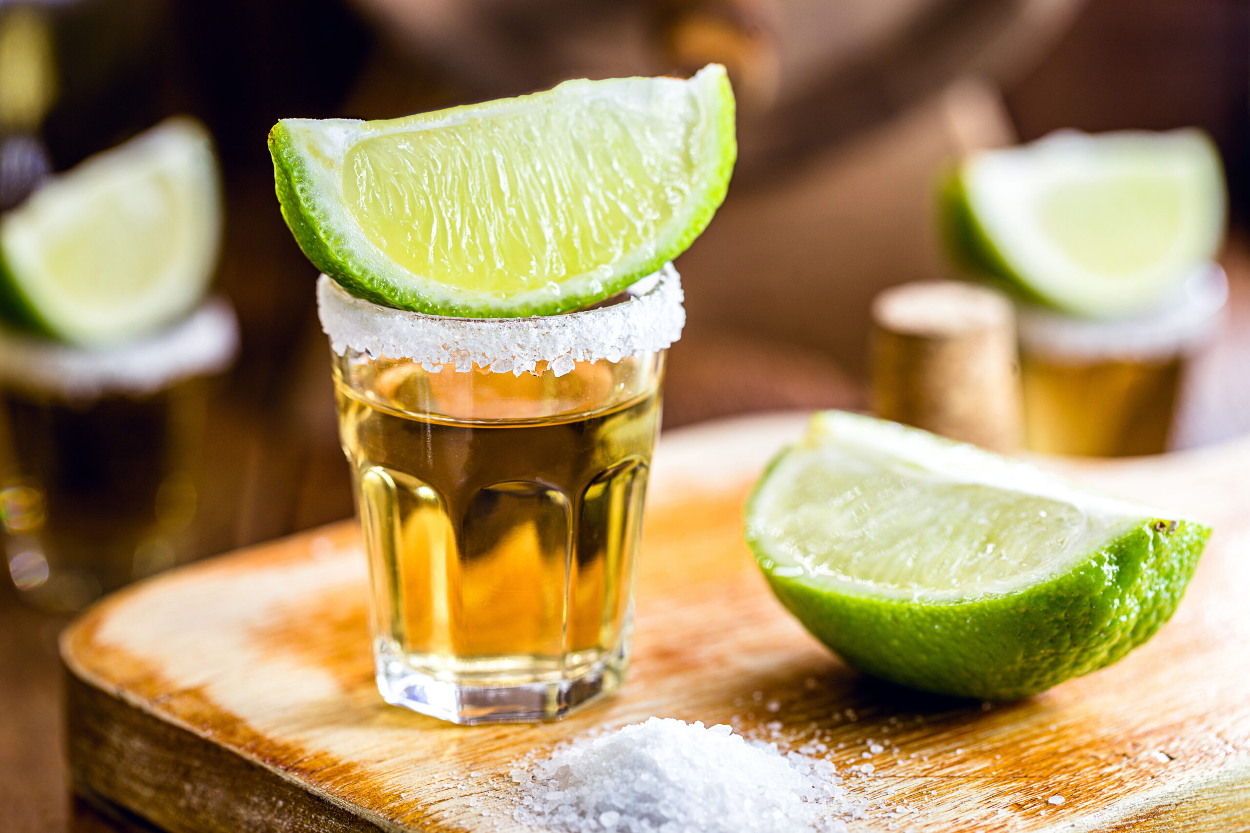 glass of tequila, a drink of Mexican culture, made of distilled alcohol, lemon, salt and blue agave. International tequila day